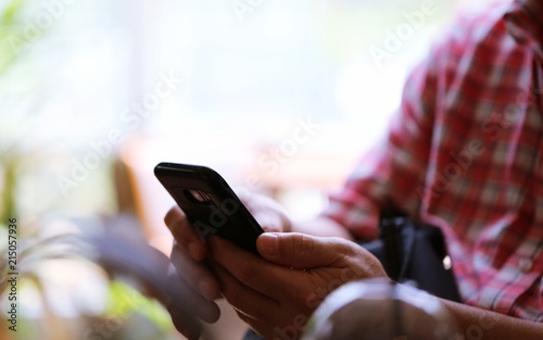 People hand using smartphone closeup interior blur background. Concept of Technology
