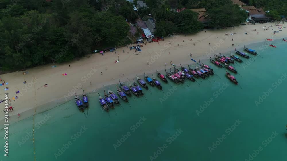Filming taxi boats at sunset beach at krabi region ao nang in thailand. People and beutiful colorfull nature like exotic paradise with palms an turquoise ocean water - aerial drone shot - advertise Filming taxi boats at sunset beach at krabi region ao nang in thailand. People and beutiful colorfull nature like exotic paradise with palms an turquoise ocean water - aerial drone shot - advertise