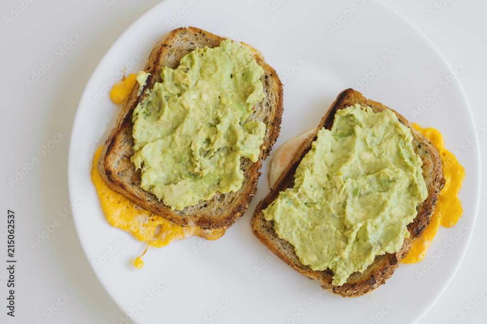 Two hot toasts with whole grain bread, eggs and avocado. Breakfast food. Healthy eating concept Two hot toasts with whole grain bread, eggs and avocado. Breakfast food. Healthy eating concept