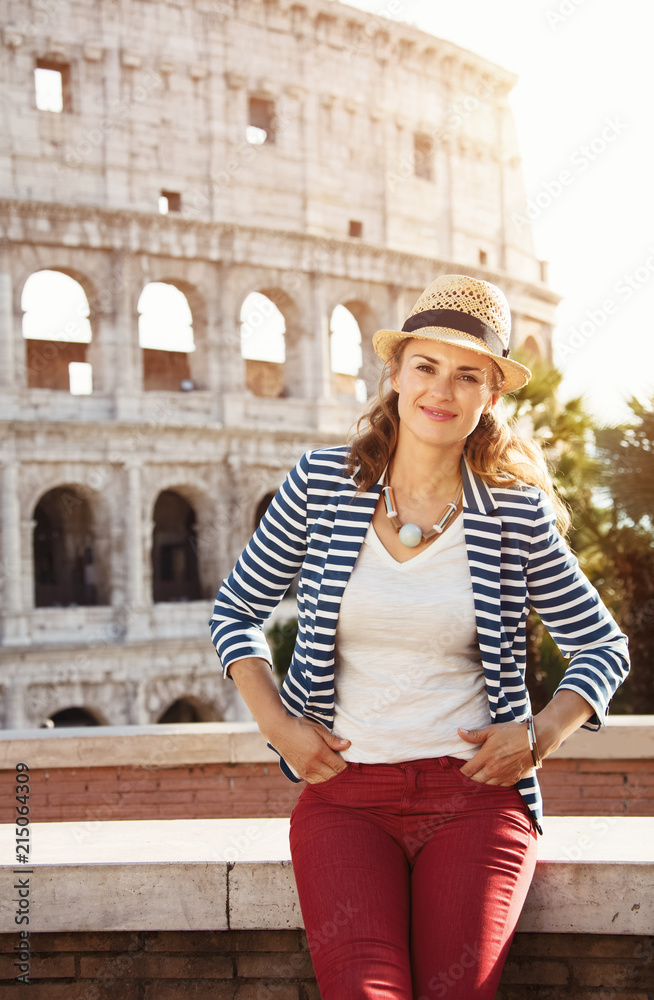 smiling trendy tourist woman in striped jacket in Rome, Italy