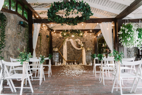 Magnificent decoration of a wedding ceremony with original details and candles. Hexagonal archway.