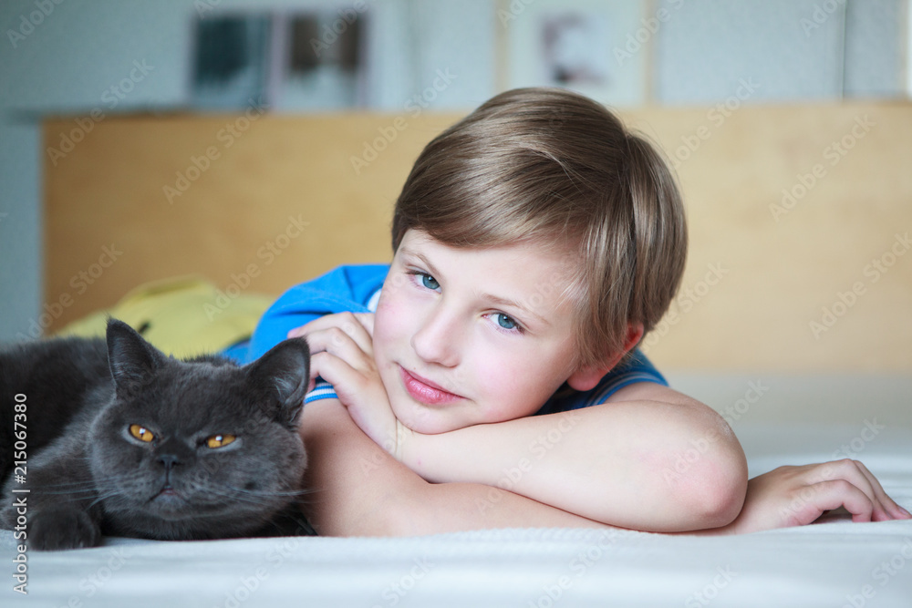 Happy cute boy lying with young british shorthair cat
Happy cute boy lying with young british shorthair cat