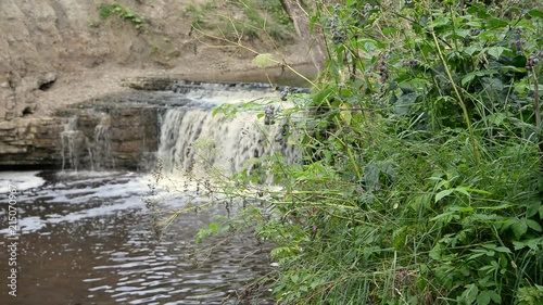 Small waterfall at cloud summer day, Russia. photo