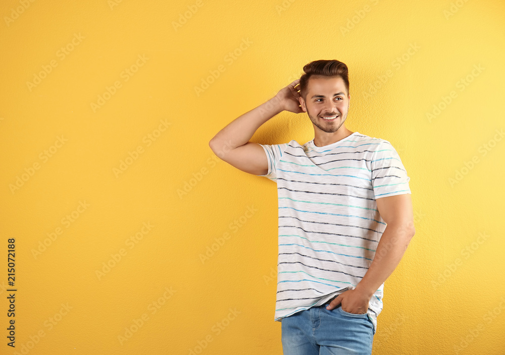 Young man in stylish jeans on color background Young man in stylish jeans on color background