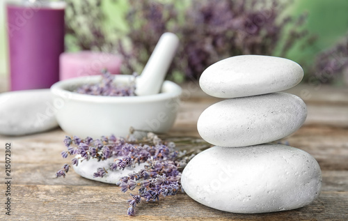 Fototapeta Naklejka Na Ścianę i Meble -  Spa stones with lavender flowers on table. Ingredient for natural cosmetic