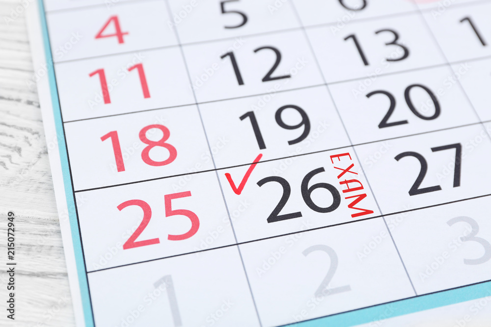 Check mark in calendar on date of 26th, close up Check mark in calendar on date of 26th, close up