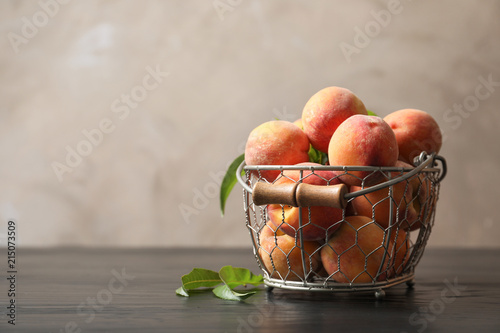 Fototapeta Naklejka Na Ścianę i Meble -  Basket with ripe peaches on wooden table