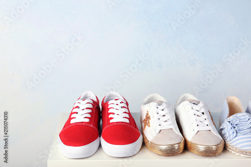 Stylish new shoes on table against light background