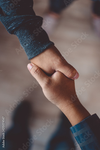 Two men shaking hands after meeting and exchanging ideas and finding mutual agreement . Successful dealing  and greeting in partner concept