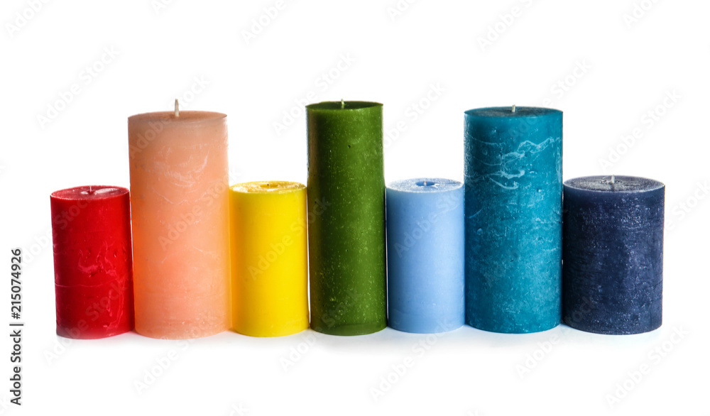 Different colorful wax candles on white background - obrazy, fototapety, plakaty 