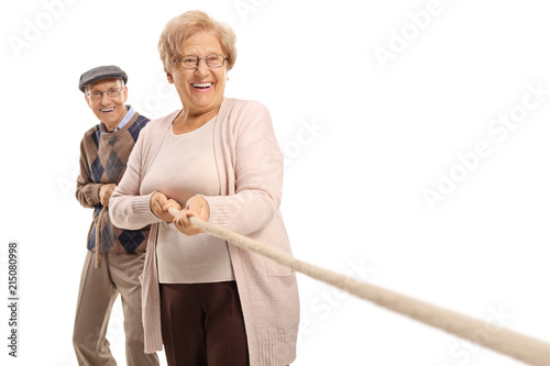 Elderly couple pulling a rope