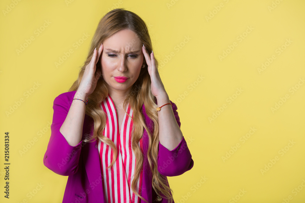 beautiful young girl in a purple jacket on a yellow background with a frustrated face beautiful young girl in a purple jacket on a yellow background with a frustrated face