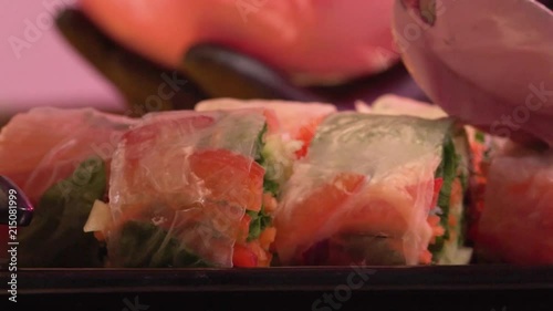 Close-up - Hand Of The Cook Puts The Sauce On The Delicious Vegetable Rolls In The Leaves Of The Burgesses. Concept Of Restaurant And Gourmet Menu photo