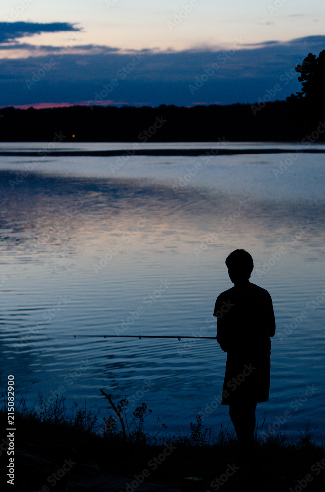 Typical evening silhouette of fisherman in action