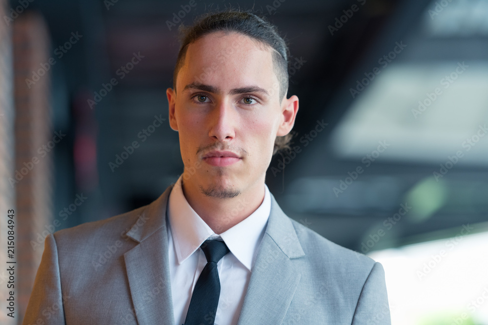 Portrait Of Young Handsome Businessman Thinking