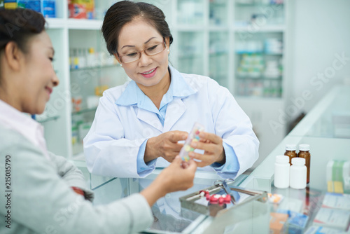 Discussing medicine with drugstore worker