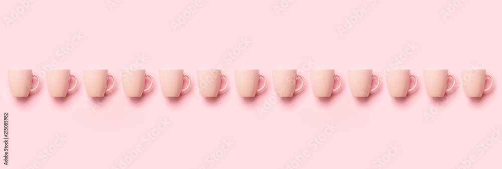 Row with pink cups over punchy background. Birthday party celebration, baby shower concept. Pastel colors pattern. Banner. Minimalist style design Row with pink cups over punchy background. Birthday party celebration, baby shower concept. Pastel colors pattern. Banner. Minimalist style design