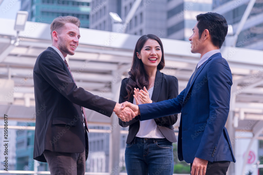 Business people group Business people group happy showing teamwork and joining hands or giving five after signing agreement or contract in office. Business people group Business people group happy showing teamwork and joining hands or giving five after signing agreement or contract in office.