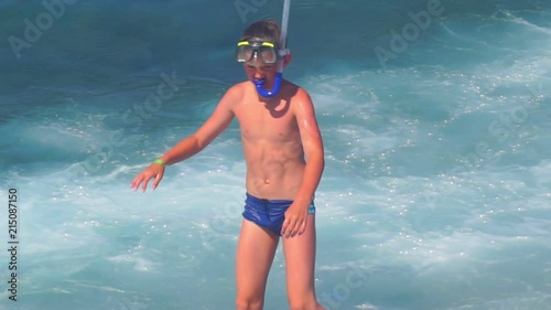 boy in a mask for swimming on the seashore.