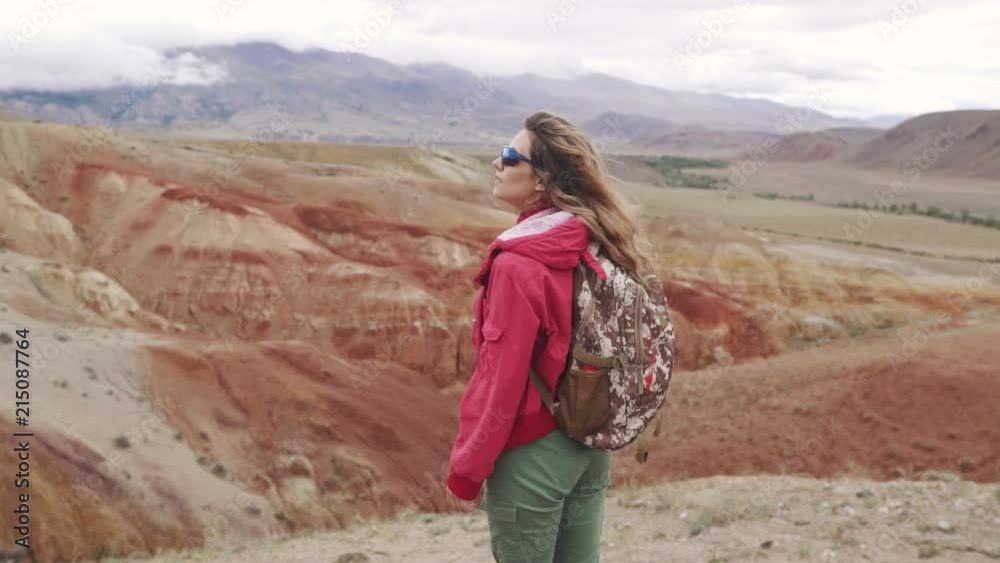 portrait of a traveler in the mountains. red mountains and red earth as on Mars portrait of a traveler in the mountains. red mountains and red earth as on Mars