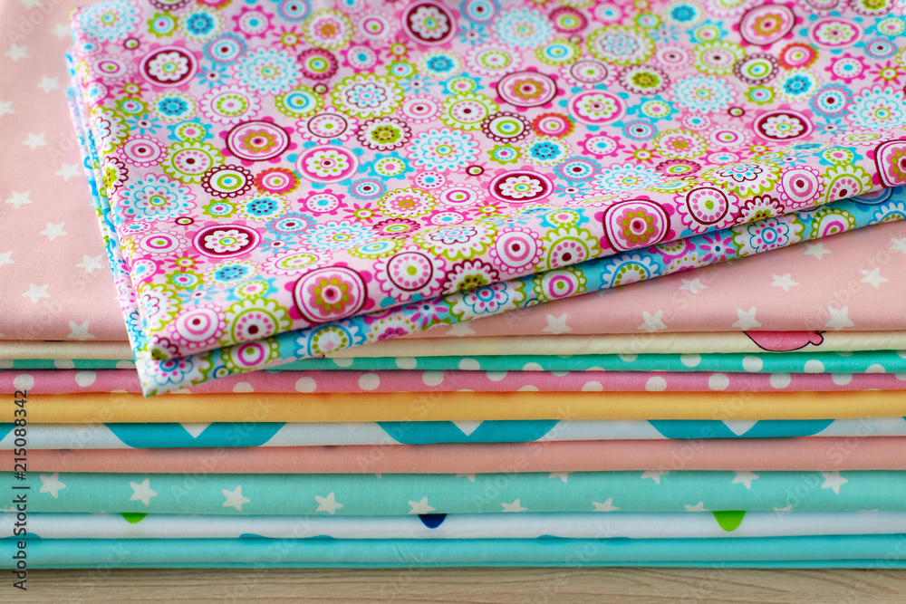 Colorful cotton fabric. A lot of cotton fabric for sewing clothes or  bedding. Natural cloth and tailoring. Stock Photo