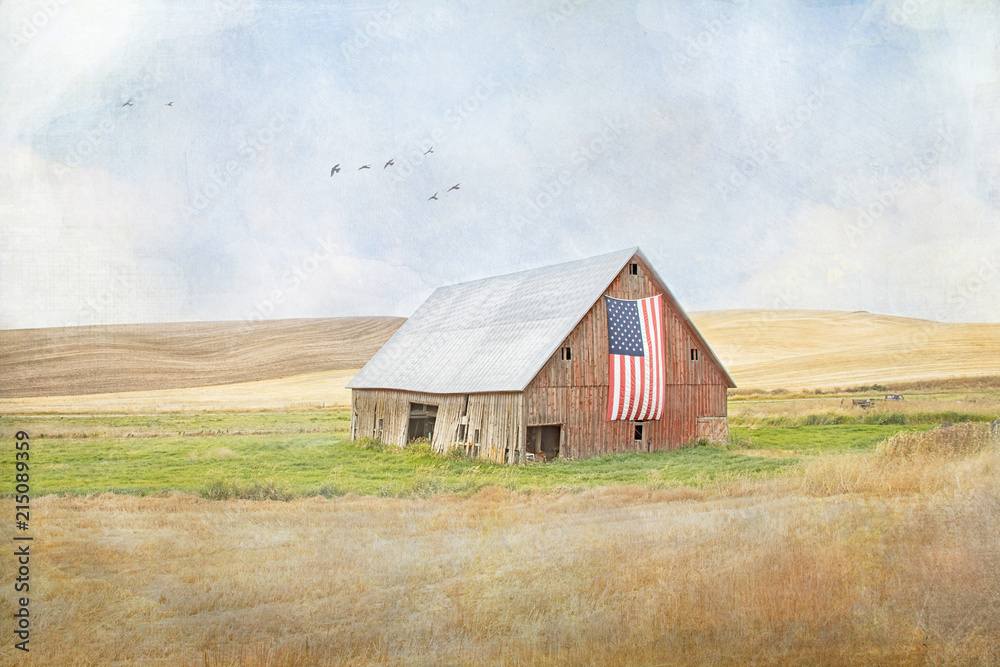 Textured photograph of an old red rickety barn with an American flag on the side