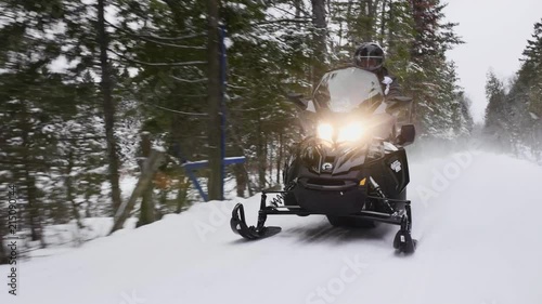 Snowmobile blazing through the trail in Québec, Canada. photo