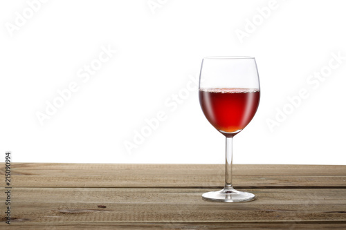 red wineglass on a wooden table isoalted on white background with clipping pat and copy space