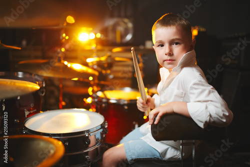 boy plays drums in recording studio