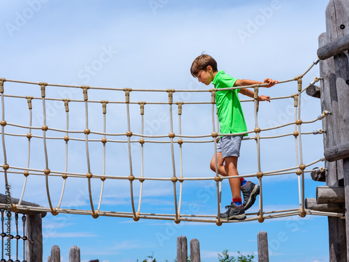 Child crossing a bridge of ropes