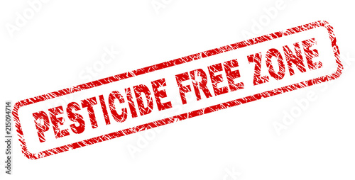 PESTICIDE FREE ZONE stamp seal print with distress style. Red vector rubber print of PESTICIDE FREE ZONE tag with unclean texture. Text tag is placed inside rounded rectangle frame.