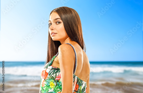 Slim young woman face and ocean landcape of blue color wiht sky. 