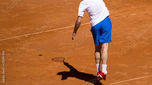 Male tennis player in action on the court on a sunny day © Augustas Cetkauskas