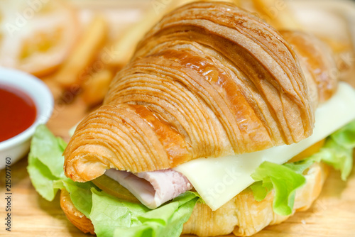 Croissant ham cheese delicious breakfast on wooden table
