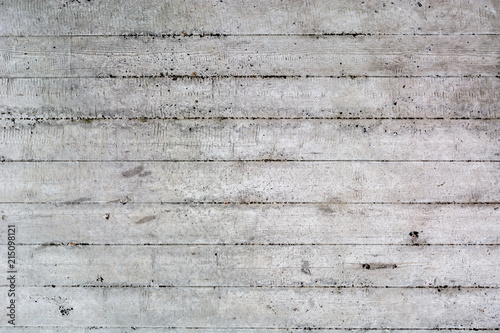 An old surface of concrete with impressions of rough boards. Gray industrial background. Copy space.