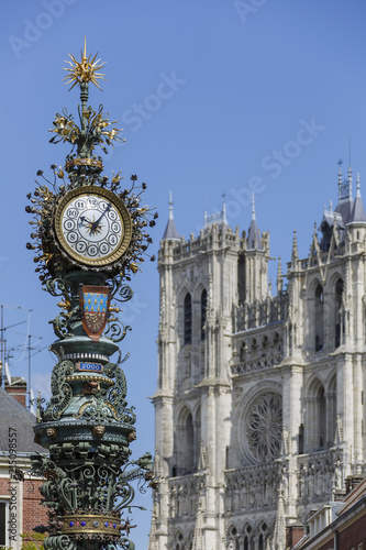 The Dewailly Clock of the year 1892 in Amiens, France.  The Amiens Cathedral is visible in the background. photo