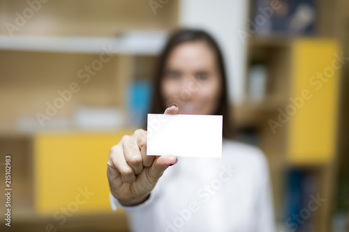 Young businesswoman holding a blank card for your message