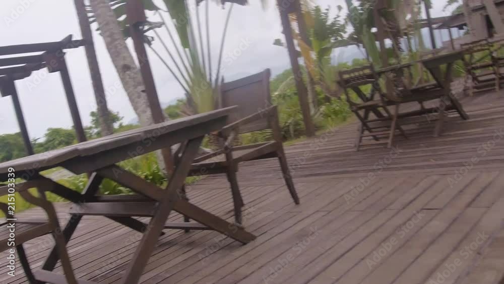 Wooden Chairs And Tables Surrounded By Flora - Slide And Spin - Left To Right Wooden Chairs And Tables Surrounded By Flora - Slide And Spin - Left To Right