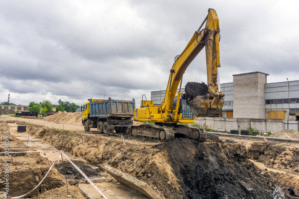 Excavator load the earth into a dump truck Excavator load the earth into a dump truck