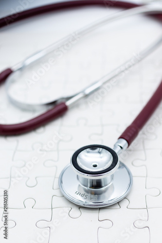 Stethoscope on jigsaw board. Image use for health medical care of family concept.