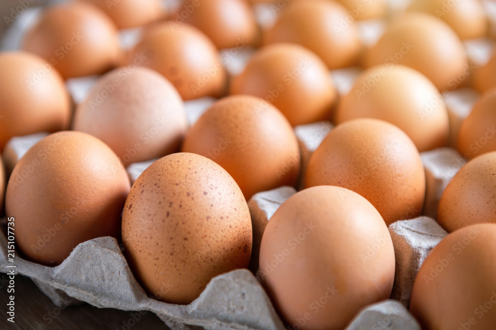 Fresh chicken eggs eggs in paper tray,egg carton on wooden background. Fresh chicken eggs eggs in paper tray,egg carton on wooden background.