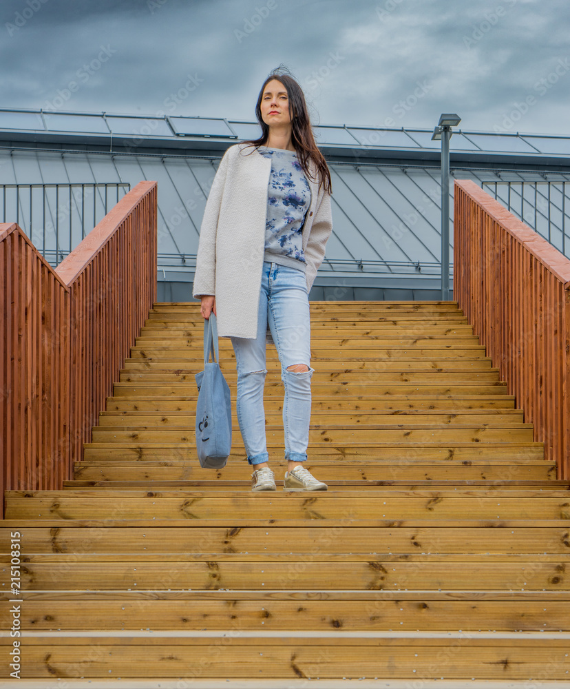 Woman on a wooden staircase Woman on a wooden staircase