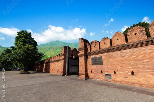 Tha Phae Gate Chiang Mai old city ancient wall and moat on Forested Mountain blue sky background with white clouds It is a major tourist attraction in Chiang Mai, Thailand. photo