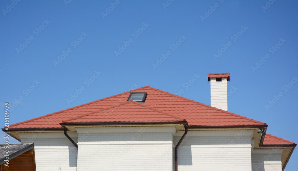 House red clay roof with attic skylight, chimney, roof gutter and copy space.