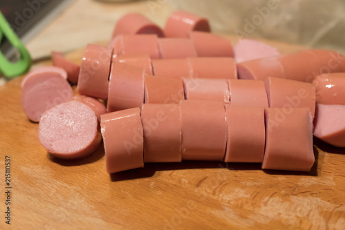 Sliced sausage rings on the wooden table photo