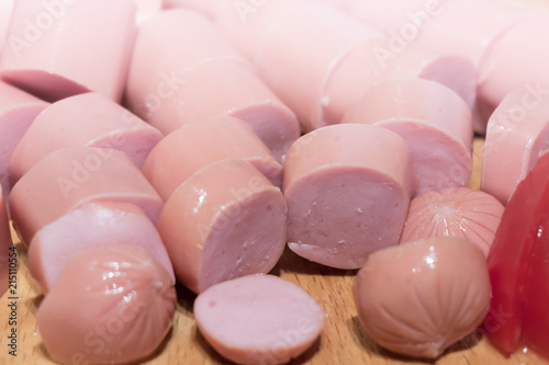 Sliced sausage rings on the wooden table photo