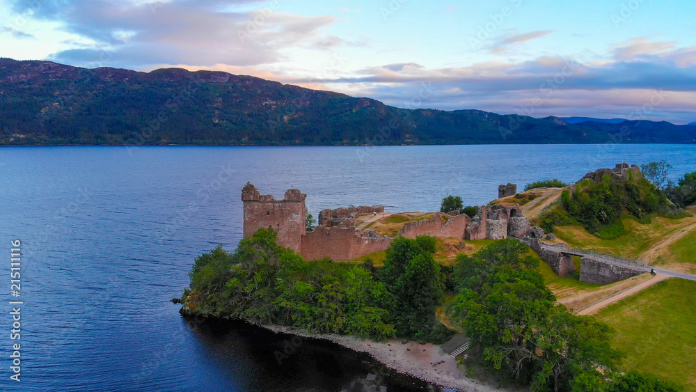 Fototapeta premium Urquhart Castle and Loch Ness in the evening - aerial drone view