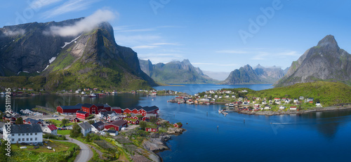 Beautiful aerial panorama of  the blue sea surrounding the fishing village  and rocky peaks Reine, Moskenes, Lofoten, Norway, sunny arctic summer 