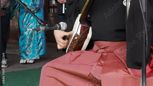 Japanese artist are playing on traditional musical shamisen instrument