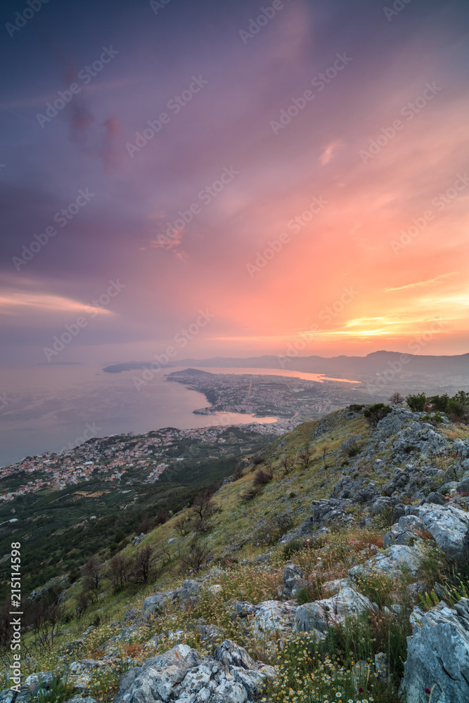 View on city Split from the mountain at sunset,rocks and grass,long exposure